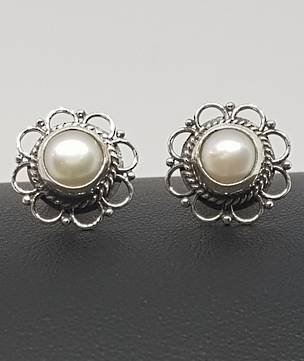 White pearl stud earrings with detailed silver frames
