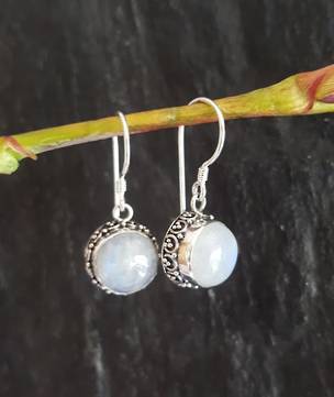 Circular silver moonstone earrings with filigree detailing
