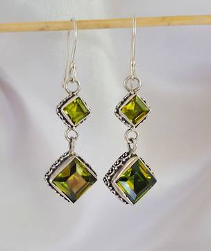 Luxurious silver peridot earrings with filigree detail