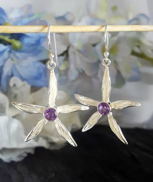 Silver daisy earrings with purple gemstone